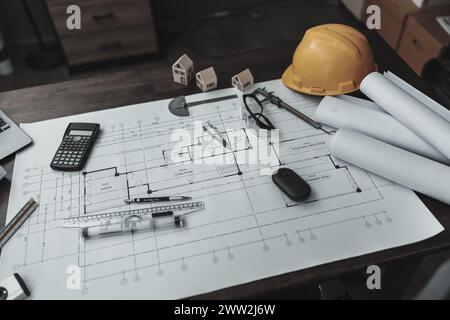 Mini model house, pencil, compass and roll blueprint plan on blueprint house plan design. Architect and engineer concept. Stock Photo