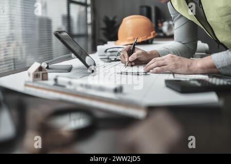 Engineering working with drawings inspection and writing on Blueprint. Engineer, Architect, Industry and factory concept. Stock Photo