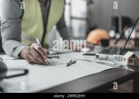 Engineering working with drawings inspection and writing on Blueprint. Engineer, Architect, Industry and factory concept. Stock Photo