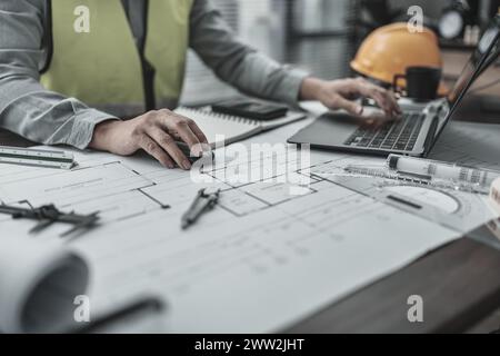 Architect working with laptop inspection on the office desk. Engineer, Architect, Industry and factory concept. Stock Photo