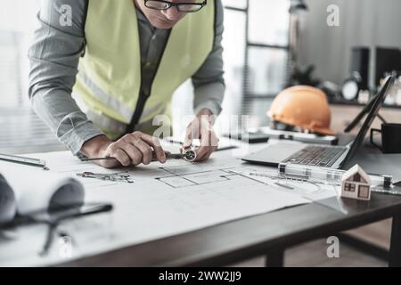 Architecture hands hold vernier caliper working and checking joint pipe scale with bathroom planning. Architecture and engineer concept. Stock Photo