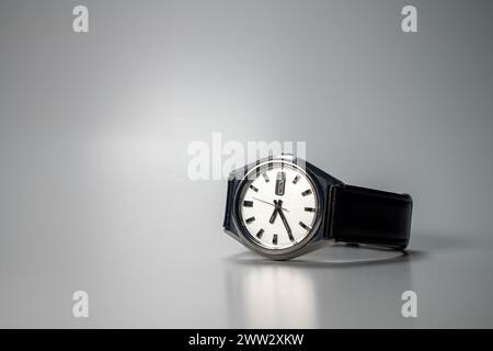 Vintage Automatic Wrist Watch With Leather Strap, Placed On Gray Surface Stock Photo