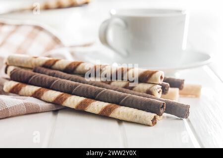 Assorted Chocolate and Vanilla Cream Filled Wafer rolls on a white table. Stock Photo