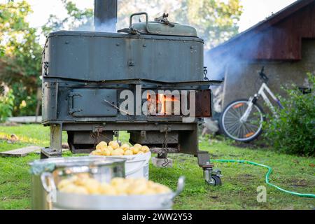 Wood burning stove. Door of outdoor stove is used as field kitchen. Old vintage firewood stove. Stock Photo