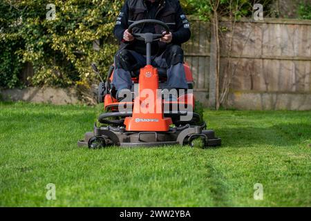 A man cutting a lawn on ride on lawn mower Stock Photo