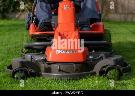 A man cutting a lawn on ride on lawn mower Stock Photo