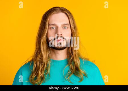 Portrait of calm focused concentarted person long curly hairdo empty space isolated on yellow color background Stock Photo