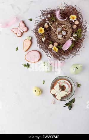 Easter table setting - colorful Easter cookies with nest decorations. Stock Photo