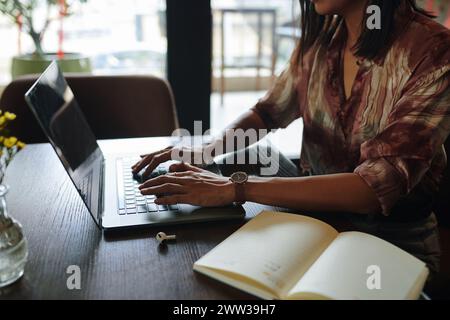 Businesswoman working on laptop in cafe Stock Photo