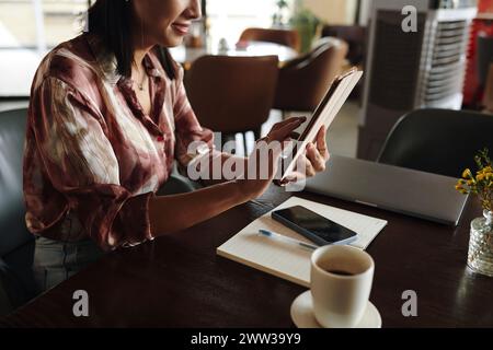 Smiling businesswoman using calendar application on tablet when planning work Stock Photo