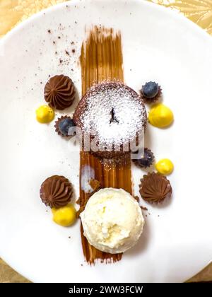 Elegant Design of a Beauty Chocolate Souffle Cake with Vanilla Ice Cream on Plate in Switzerland Stock Photo