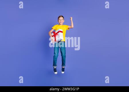 Photo of beautiful cheerful cute boy wear trendy yellow clothes celebrate birthday receiving gift isolated on violet color background Stock Photo