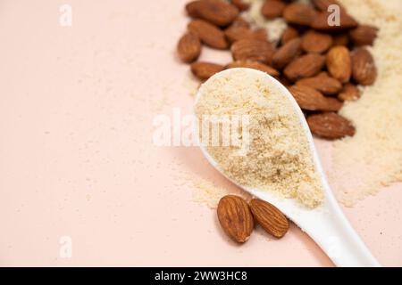 Almond flour in spoon close-up on beige background copy space for banner for text. Stock Photo