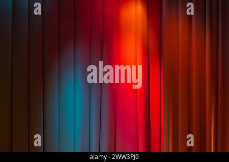 Closed wavy curtain with colorful spot lights, background photo texture Stock Photo