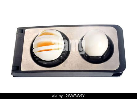Egg slicer in front of white background Stock Photo