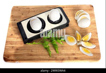 Egg slicer in front of white background Stock Photo