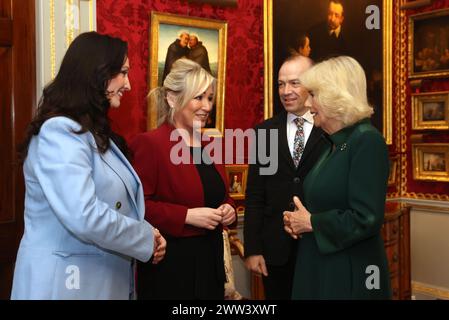 Queen Camilla (right) speaks with First Minister Michelle O'Neill (2nd left), Deputy First Minister Emma Little-Pengelly (left) and Northern Ireland Secretary Chris Heaton-Harris (2nd right) as she attends an event hosted by the Queen's Reading Room to mark World Poetry Day at Hillsborough Castle in Belfast, during her two-day official visit to Northern Ireland. Picture date: Thursday March 21, 2024. Stock Photo