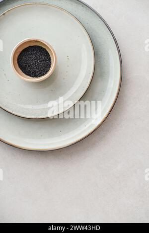 Two plates of different sizes and tiny bowl on light backgrount, top view Stock Photo