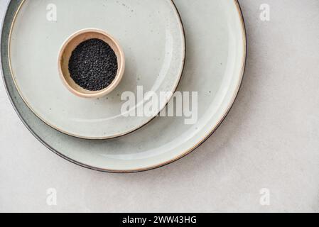 Two plates of different sizes and tiny bowl on light backgrount, top view Stock Photo