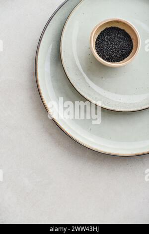 Two plates of different sizes and tiny bowl on light backgrount, top view Stock Photo