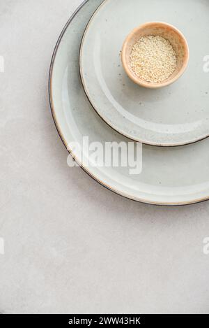 Two plates of different sizes and tiny bowl on light backgrount, top view Stock Photo
