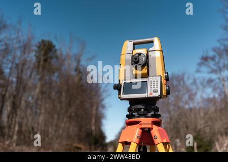 land surveying total station instrument on a tripod in the field Stock Photo