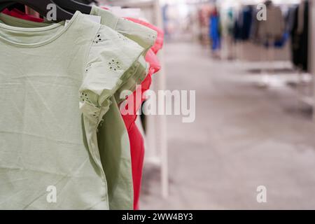 Children clothes hanging on hangers in the shop Stock Photo