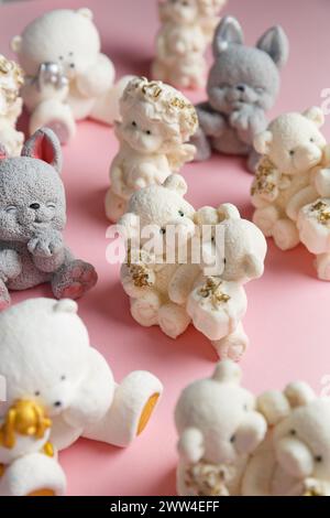 Chocolate figurines of angels and animals for decorating cakes on a pink background. Confectionery, bakery concept Stock Photo
