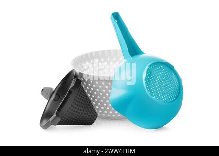 Set of plastic sieves of different shapes, sizes and colors, isolated on a white background. Kitchen utensils made of eco-plastic for washing, drying, Stock Photo