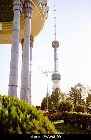 The Tashkent Television TV Tower Toshkent Teleminorasi and memorial column in the park at sunset in Uzbekistan Stock Photo