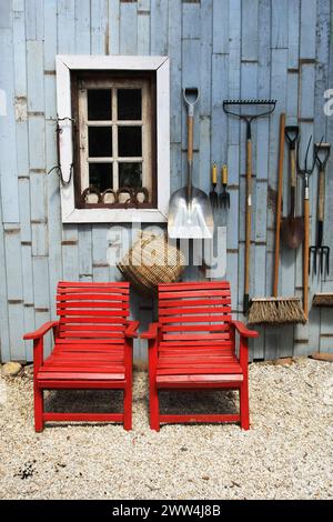 Double red chair and farmer's farming equipment background Stock Photo