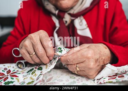 seamstress hands fixing dress with scissors Stock Photo