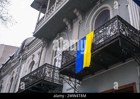 TBILISI, GEORGIA - MARCH 11, 2021. Ukrainian flag waving hang on private apartment balcony in support of Ukraine Stock Photo