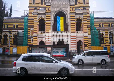 TBILISI, GEORGIA - MARCH 11, 2021. Ukrainian flag waving hang on Georgian National Opera and Ballet Theater of Tbilisi balcony in support of Ukraine Stock Photo