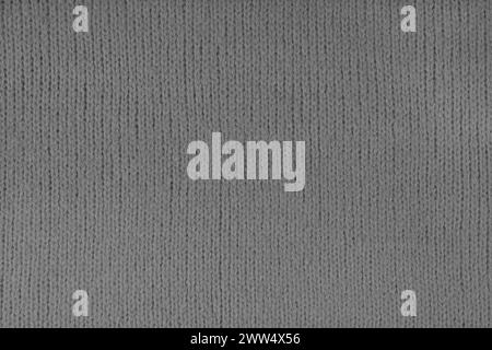 Gray knitted woolen jersey fabric, sweater, pullover texture background. Fabric abstract backdrop, cloth wallpaper Stock Photo