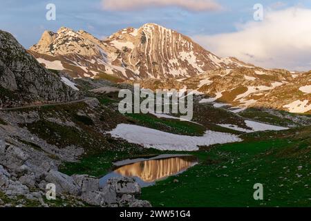 Sunset view of Prutaš mountain in Durmitor National Park in Montenegro. Snow remains on the mountain. Famous hiking destination. Stock Photo