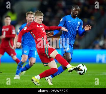 Wales' Jordan James (left) and Finland's Glen Kamara battle for the ball during the UEFA Euro 2024 Qualifying play-off match at the Cardiff City Stadium, Cardiff. Picture date: Thursday March 21, 2024. Stock Photo