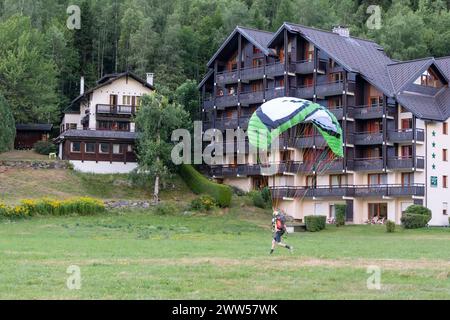 Paraglider on the meadow landing point near the centre of the alpine town in summer, Chamonix, Haute Savoie, France Stock Photo