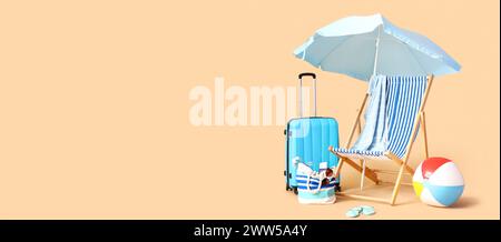 Deckchair, suitcase and beach accessories on beige background with space for text. Travel concept Stock Photo