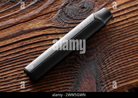Caen, France - March 18, 2024: A vape and a box of vape juice sit on a blue  surface. The box is labeled with the brand name VUSE Pro Stock Photo