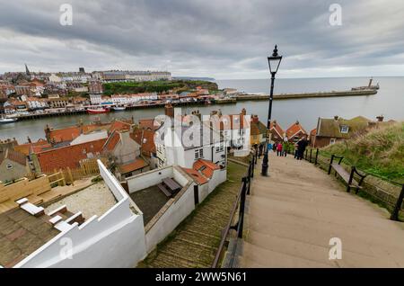 This atmospheric photograph captures the historic St. Mary's Church graveyard in Whitby, England, overlooking the North Sea. The aged tombstones... Stock Photo