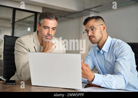 Busy business team people of two executive men working in office on laptop. Stock Photo