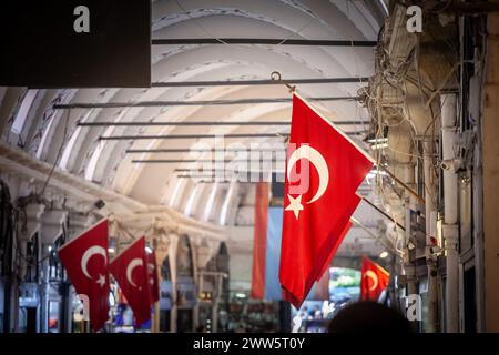 Picture of a turkish flags in the alleys of the Istanbul Grand Bazaar. Also known as Kapalicarsi, it is one of the largest and oldest covered markets Stock Photo