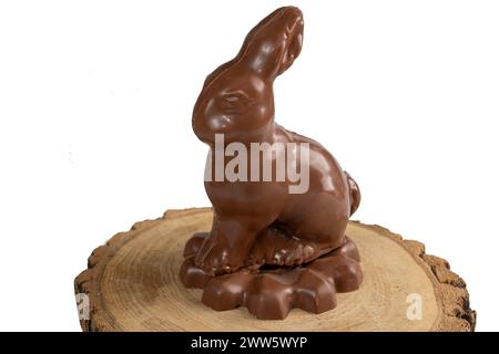 Milk chocolate in the shape of a rabbit on a wooden board 3.jpg Stock Photo