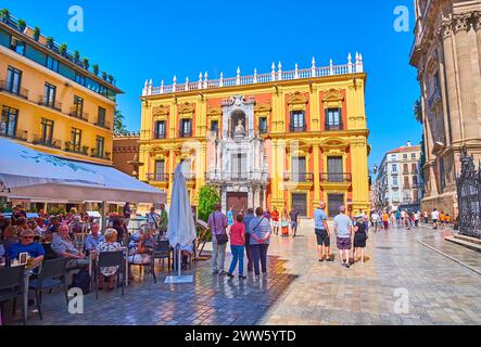 MALAGA, SPAIN - SEPT 28, 2019: Plaza del Obispo with outdoor dinings and ornate sculptured Episcopal Palace, on Sept 28 in Malaga Stock Photo