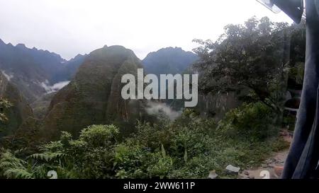 Enchanting view of mist-covered mountains in a tropical forest in Machu Picchu - Peru Stock Photo