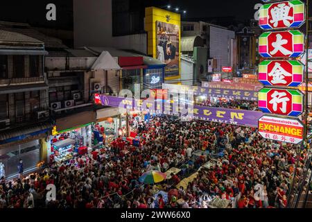 View of the crowded street of Yaowarat with people celebrating the Chinese New Year 2024 Festival in Chinatown, Bangkok, Thailand. Stock Photo