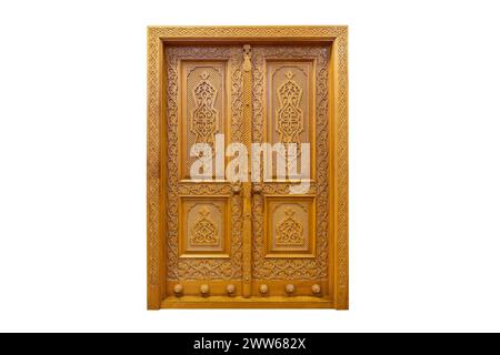Beautiful large wooden door on a white background wall. Hand carved, vertical pattern Stock Photo