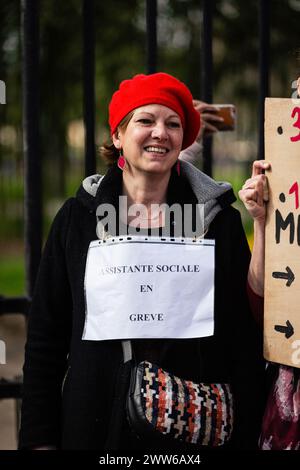 Paris, France. 19th Mar, 2024. A woman holds a placard that says 'social worker on strike' during the demonstration of the civil workers. The civil service strike took thousands of people to the streets in various demonstrations across France. In Paris, a demonstration of national education workers joined the civil service workers to demand an increase in salaries and to protest against the current French government. (Photo by Telmo Pinto/SOPA Images/Sipa USA) Credit: Sipa USA/Alamy Live News Stock Photo