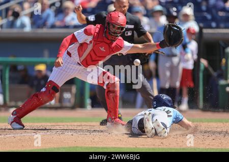 Clearwater, FL: Tampa Bay Rays left fielder Jake Mangum (72) is safe sliding under the tag of Philadelphia Phillies catcher Aramis Garcia (41) during Stock Photo